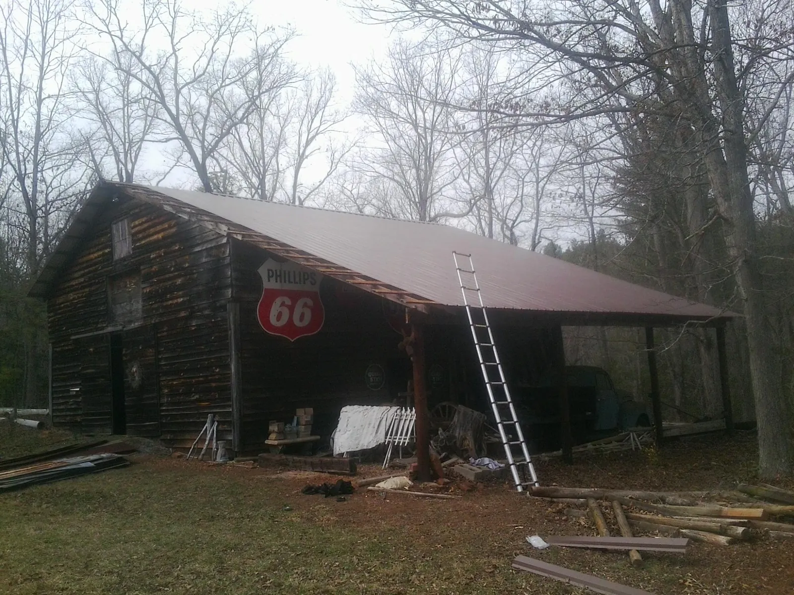 New metal roof on an open sided timber barn with a vintage sign in Davey