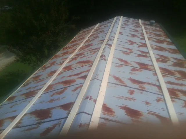 Rusted metal roof panels with new wood purlins before replacement — Storm Damage Roof Repair in Davey by Roofing Brothers