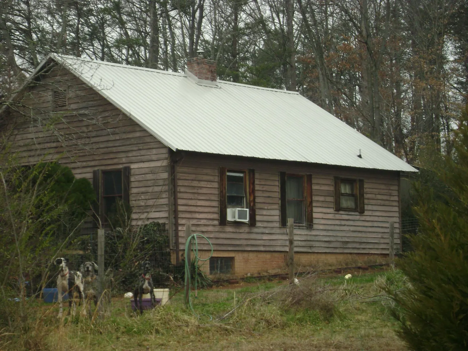 White metal roof on an old wood sided farmhouse, from a Metal Roof Installation job in Davey